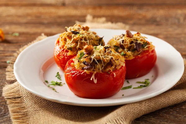 Baked stuffed tomatoes. Stuffed with chanterelles. Top view of the dish.