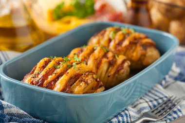 İsveççe fırında patates. Hasselback. Peynir ve pastırmayla doldurulmuş. Üst görünüm. 