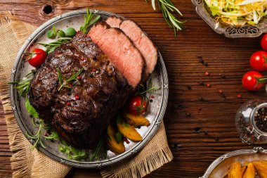 Kızarmış göğüs eti. Kırsal tarzda, doğal ahşap arka plan. Karanlık stil. Üst Manzara. Düz yatıyordu. 