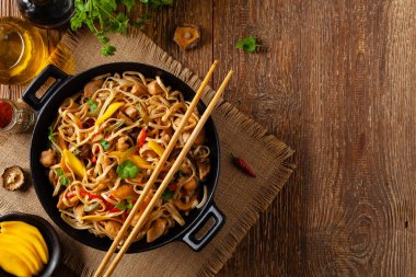 Mangolu kızarmış tavuk ve erişteli hindistan cevizi sütü. Bir tavada hazır. Üst görünüm. 