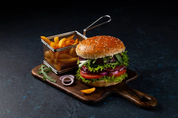 Vegetarian burger. Dark mood. Black background.