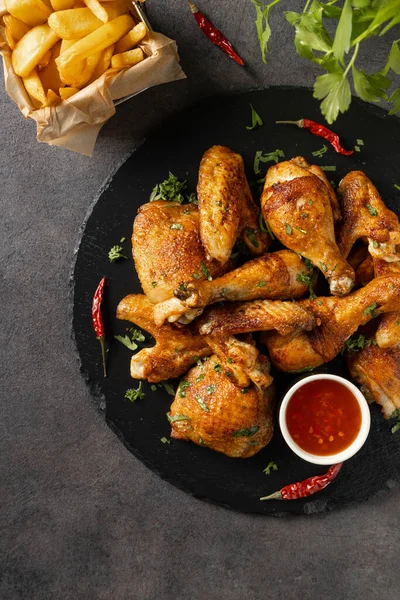 Mix Baked Chicken Pieces Served Hot Sauce Fries Dark Background — Stock Photo, Image