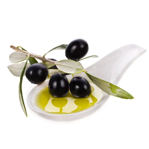 Black olives in olive oil on white background — Stock Photo, Image