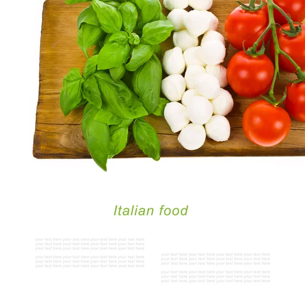 Ripe tomatoes and mozzarella balls garnished with basil — Stock Photo, Image