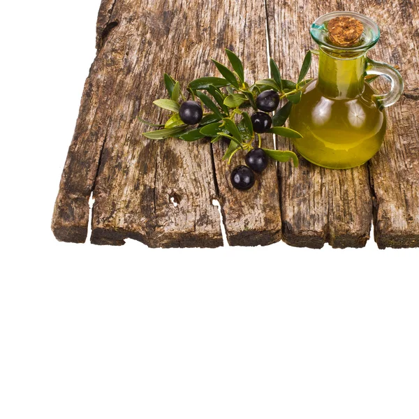 Olive oil in a small glass bottle with olive tree branches — Stock Photo, Image