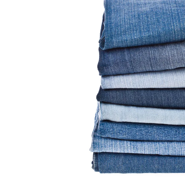 Lot of different blue jeans in the stack — Stock Photo, Image