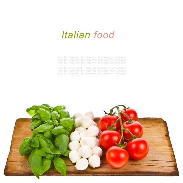 Ripe tomatoes and mozzarella balls garnished with basil — Stock Photo, Image