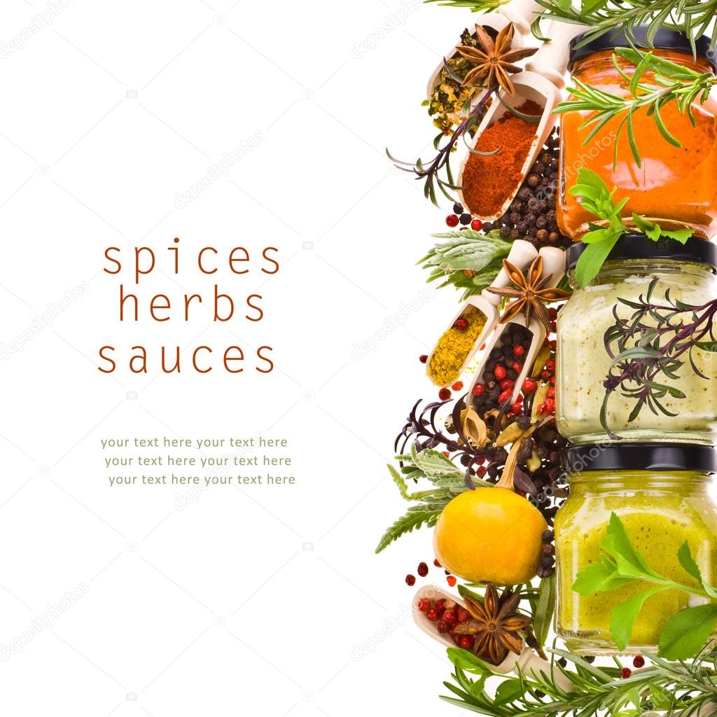 Dry spices, fresh herbs and cooking sauces in jars