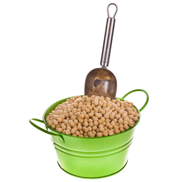 Soybeans - are poured into a green metal bucket and a metal scoop isolated on white background — Stock Photo, Image