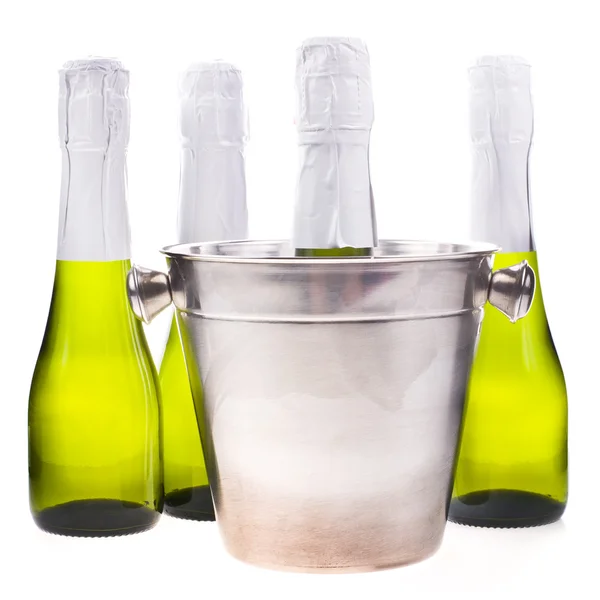 Four green small bottle of champagne without a label and bucket isolated on white background — Stock Photo, Image