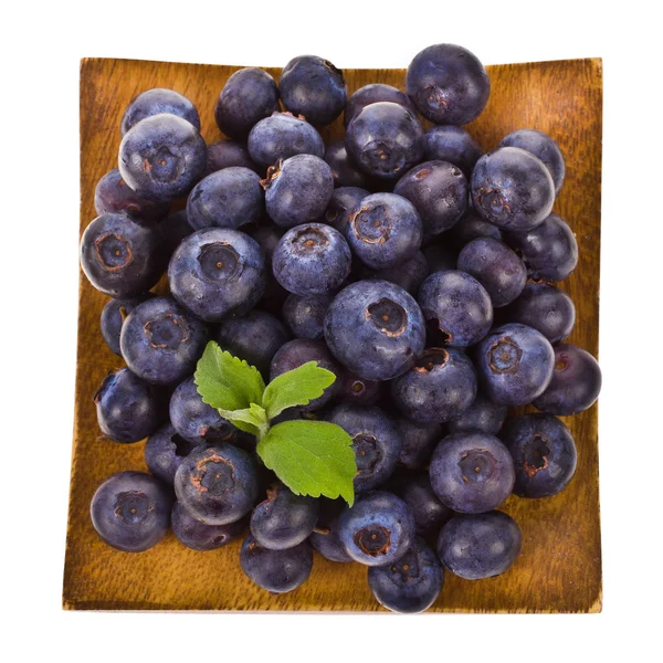 Blueberries on a wooden tray isolated on white background — Stock Photo, Image