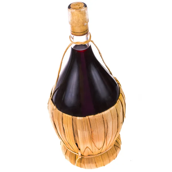 Red wine in a pot-bellied bottle with a wicker basket isolated on white background — Stock Photo, Image