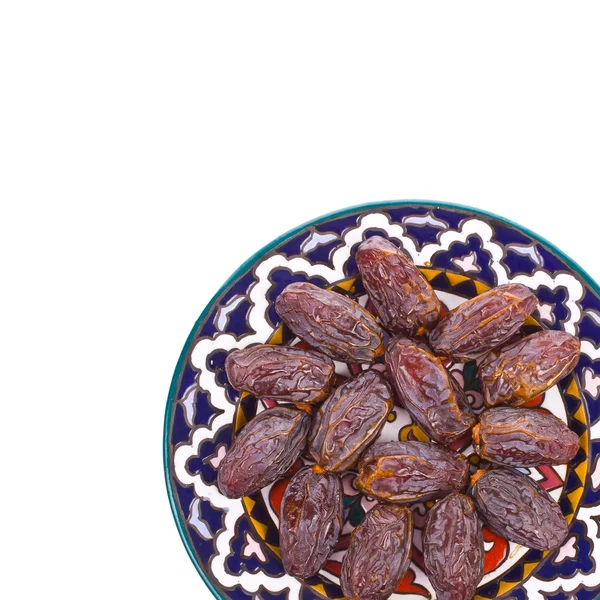 Large dry dates on a plate isolated on white background — Stock Photo, Image