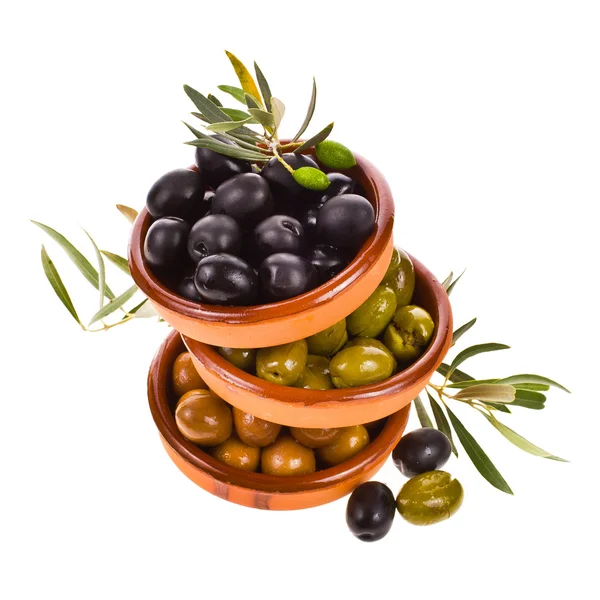 Different varieties of olives marinated in traditional clay bowls decorated with branches of olive tree isolated on white background — Stock Photo, Image