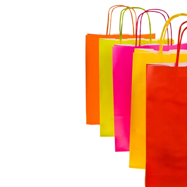 Brightly colored paper shopping bags isolated on white background — Stock Photo, Image