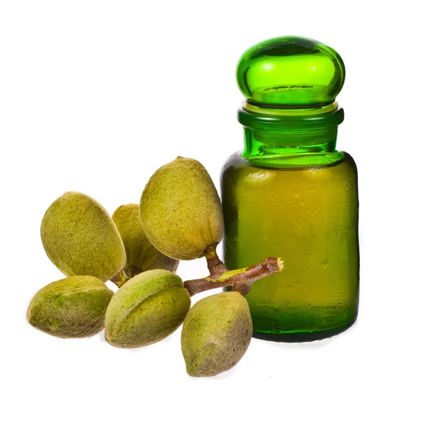 Indoor decorative bottle of green glass, filled with oil and almonds isolated on white background — Stock Photo, Image