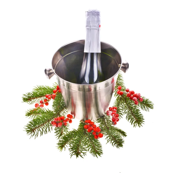 Bottle of champagne is in a steel bucket with tree branches and red berries — Stock Photo, Image