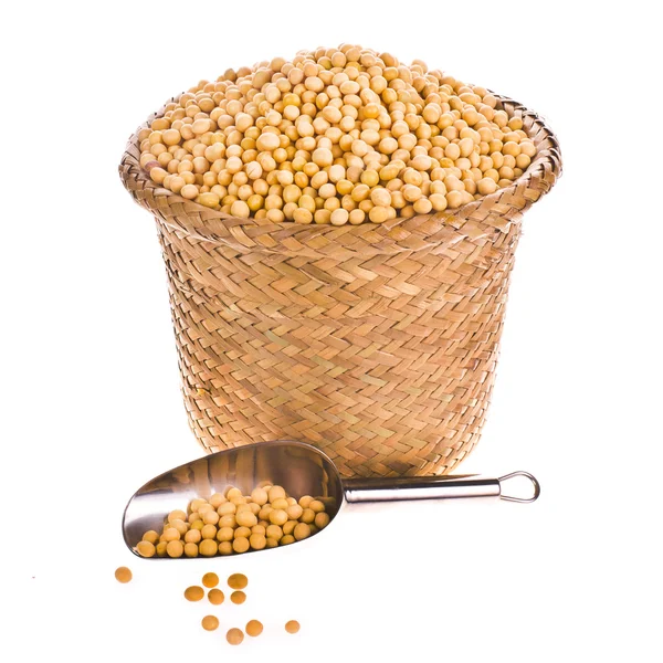 Soybeans with a metal spoon in a small wicker basket — Stock Photo, Image