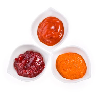 Three different sauces in a white bowl clipart