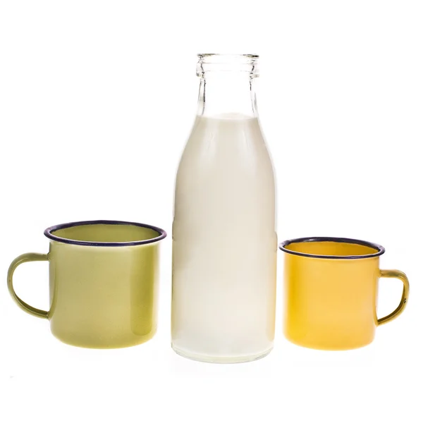 Bottle full of milk and yellow enamel mug — Stock Photo, Image