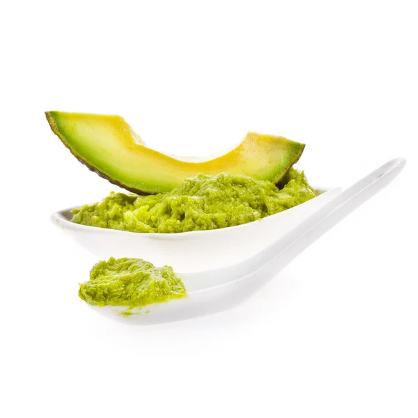 Fresh guacamole in a white bowl with a spoon — Stock Photo, Image