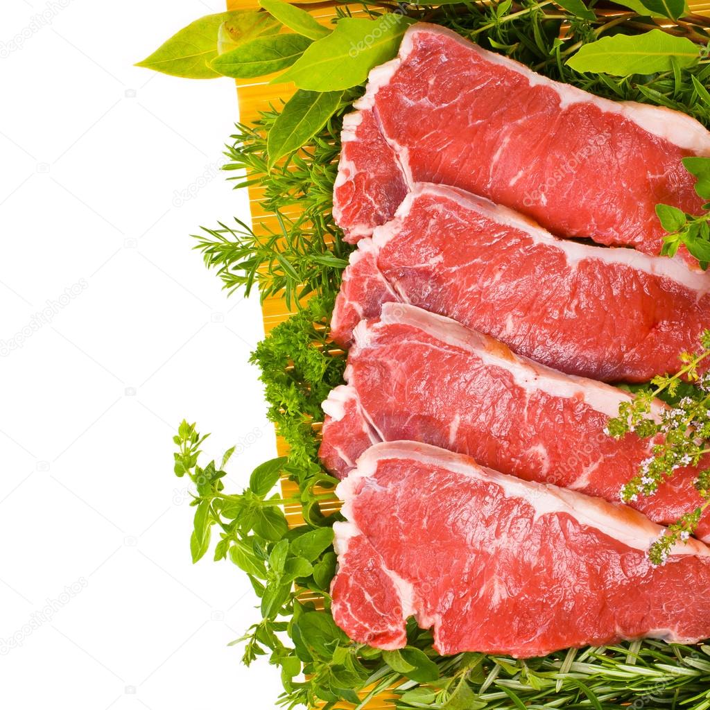 Fresh meat - fresh steaks on a yellow mat