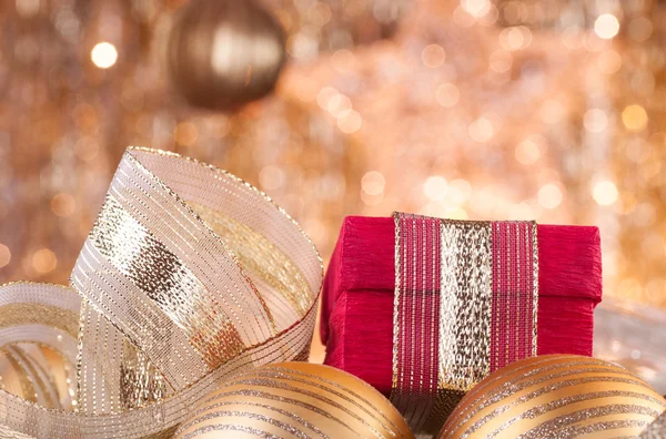 Gouden kerstballen en rood vak — Stockfoto