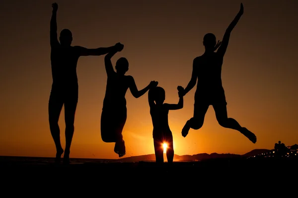 Sunset silhouette of family — Stock Photo, Image