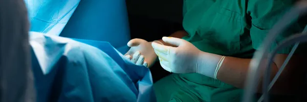 Médicos manos en guantes estériles durante la cirugía. — Foto de Stock