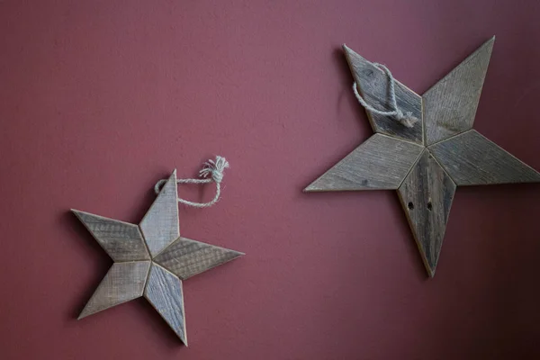 Large wooden stars hang on the wall — Stok fotoğraf