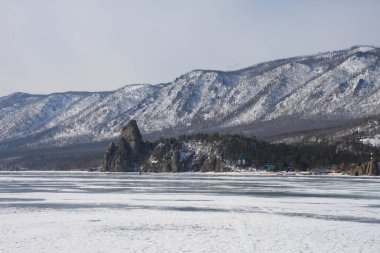 snow-capped mountains against a frozen lake in winter