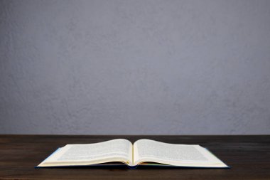 Open Bible. The book is on the table. Prayer.