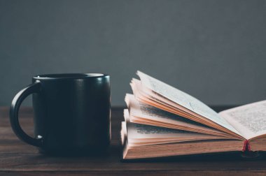 Open bible pray. Holy bible book on the table. A cup. Prayer is praying.