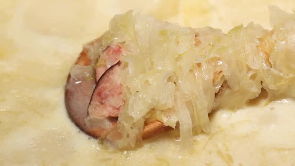 Traditional cabbage soup boil. Detail on wooden spoon — Stock Video