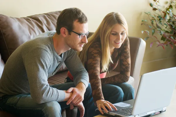Jeune couple regardant ordinateur portable Image En Vente