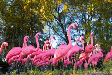 Dramatic Fake Flamingo Flock In The Forest clipart