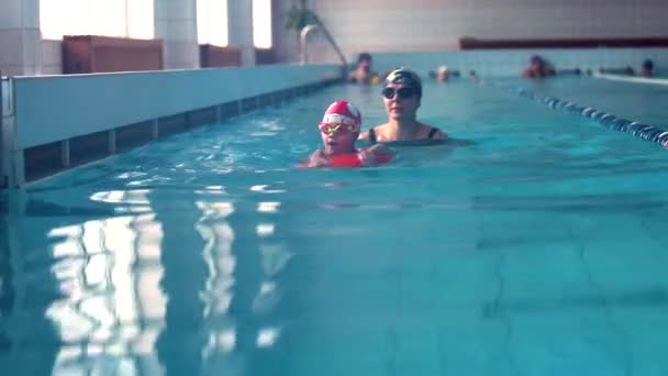 Retrato Mãe Treinador Aprendendo Nadar Com Menina Prancha Vibração Piscina — Vídeo de Stock