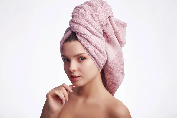 年轻迷人的女人头上拿着毛巾 看着相机 白色的背景上挂着笑容 文字的复制空间 面部护理和头发概念 — 图库照片