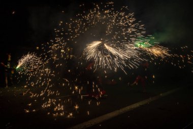 Barcelona, Catalonia Spain - 24.09.2021: the traditional fire show, the finishing of famous Fiestas de Gracia, favourite attraction for locals and tourists. People dressed as devils with fireworks