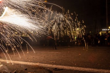 Barselona, Katalonya İspanya - 24.09.2021: Geleneksel yangın gösterisi, ünlü Fiestas de Gracia 'nın finali, yerel halk ve turistler için favori eğlence merkezi. İnsanlar şeytan gibi giyinip havai fişek attılar.