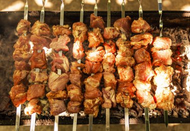 Barbecue grill with various kinds of meat. Cook pork meat on grilled meat. Food cooked with grilling barbecue in backyard of house