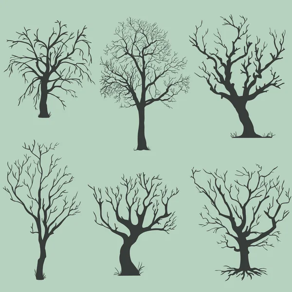Vector set of silhouettes of bare trees — Stock Vector