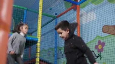 Çocuklar eğlence merkezindeki trambolinlerde zıplıyorlar. Trambolin eğlence merkezi. Oyun odası