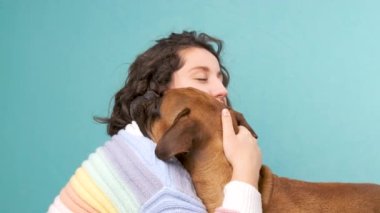 Kadın boksör köpeğini okşuyor ve ona sarılıyor. Hayvanlar ve evcil hayvanlar..