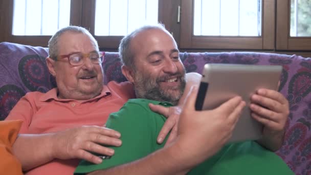 Positive Homosexual Bearded Men Watching Funny Video Modern Tablet While — 图库视频影像
