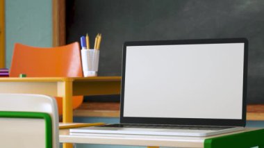 Modern laptop with white blank screen placed on desk against classroom at school. Ready for your design. 3d animation