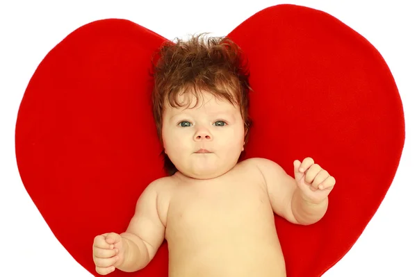 The surprised baby against heart Royalty Free Stock Photos