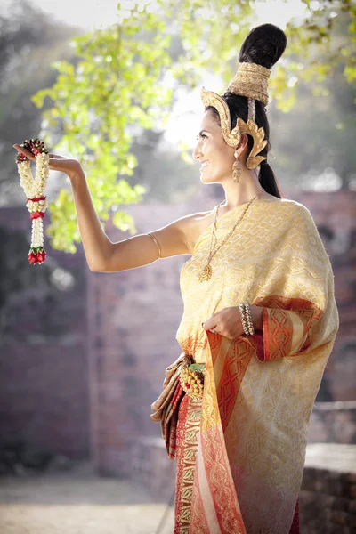 Woman wearing typical thai dress with thai style temple background — Stock Photo, Image