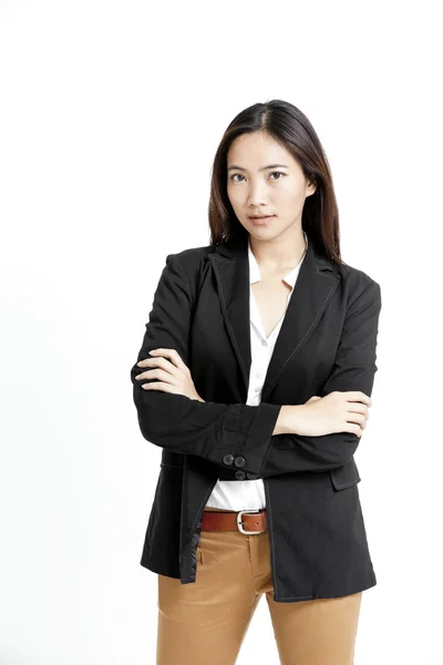 Portrait of a happy young business woman standing with folded hand against white background — Stock Photo, Image