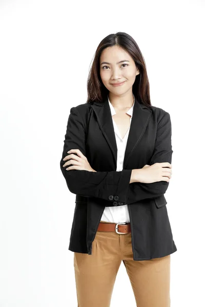 Portrait of a happy young business woman standing with folded hand against white background — Stock Photo, Image